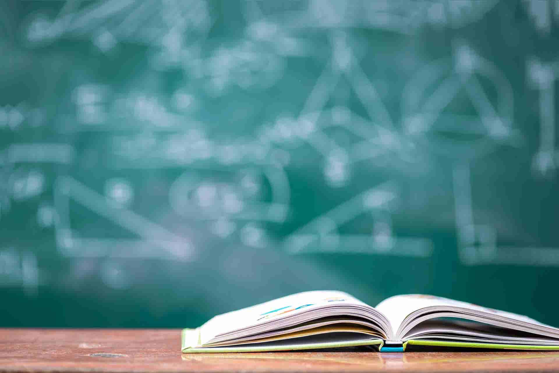 Green board and a book on a table